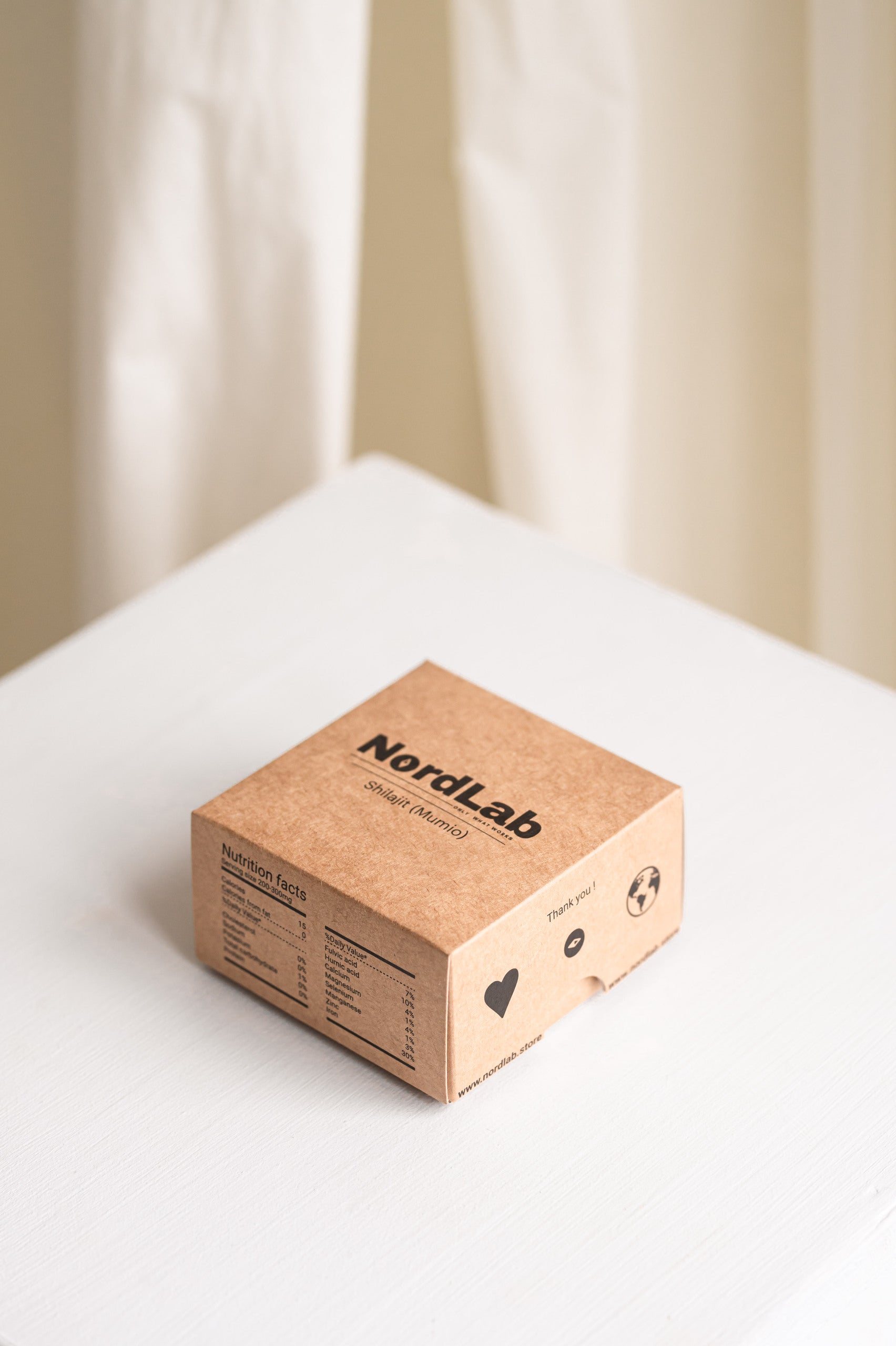 Kraft paper box with 'NordLab' branding on a white surface