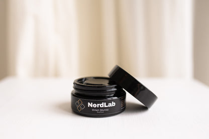 Black jar with 'NordLab' branding on a light background